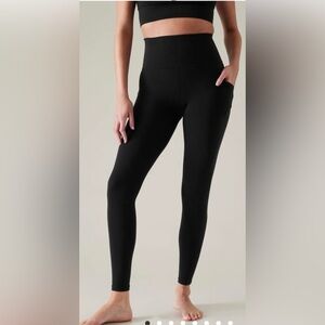 Athleta women’s XS pocketed black leggings w/gray stripes on the bottom sides